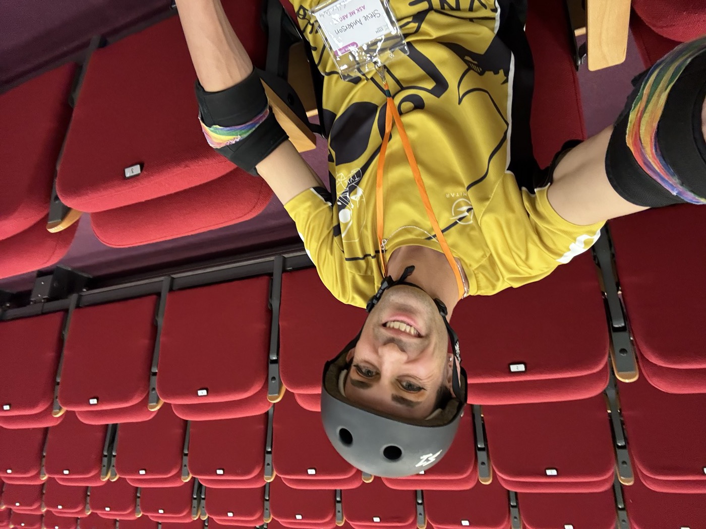Eve in roller-derby kit in an auditorium